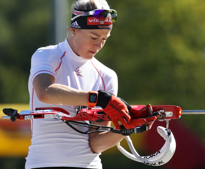 Maren Hammerschmidt loading biathlon rifle.